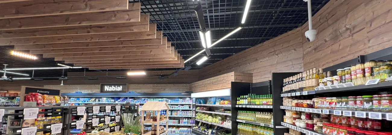 LED linear light manufacturer track panels over a supermarket aisle