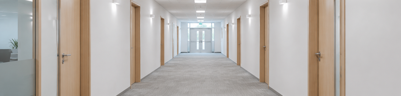 White sensor bulkhead in office corridor on central battery backup